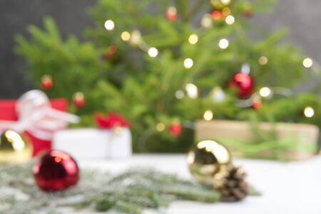 Beautiful Christmas composition. Gift boxes and christmas decor with christmas tree on background. Xmas backdrop for your greeting card with space for text.の写真素材