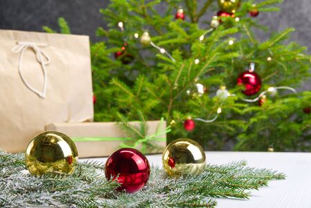 Beautiful Christmas composition. Gift boxes and christmas decor with christmas tree on background. Xmas backdrop for your greeting card with space for text.の写真素材