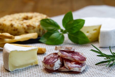 Cheese appetizer selection or Cheese and wine party table. Brie cheese, bread sticks and salami is great appetizer tostart your dinner.の写真素材