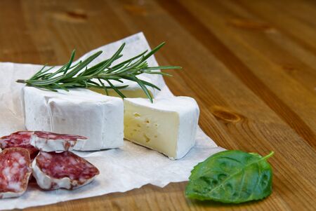 Cheese appetizer selection or Cheese and wine party table. Brie cheese, bread sticks and salami is great appetizer tostart your dinner.の写真素材