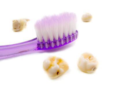 Pair of pink and blue toothbrushes in glass at bathroom isolated over white background. photoの写真素材