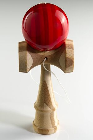 Kendama japanese wooden toy on isolated on white. Wood toy with red bal.の写真素材