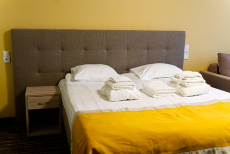 lean bed in the hotel room of the spa center. ray soft bed and orange bedspreadの写真素材