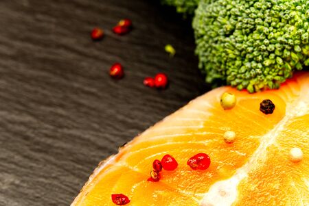 Fresh salmon steaks with aromatic herbs, spices, peppers and lemon. Healthy food, diet or cooking concept. for food background with copy space.の写真素材