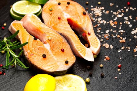 raw salmon steak on wooden board close upの写真素材