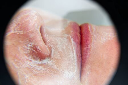 beautiful young woman with natural moisturizing mask on the face. Beauty treatment. Anti-aging skin...
