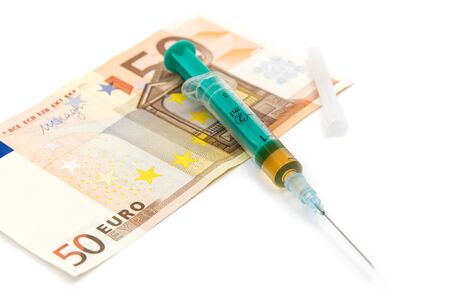 Money and pills with drugs and a syringe on isolated on whiteの写真素材