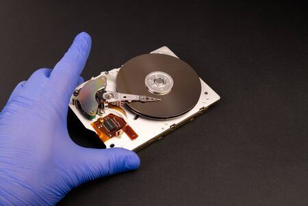 A hard disk drive HDD, hard disk, hard drive, or fixed disk is an electro-mechanical data storage device that uses magnetic storage to store and retrieve digital data using one or more rigid rapidly rotating platters coated with magnetic material.の写真素材