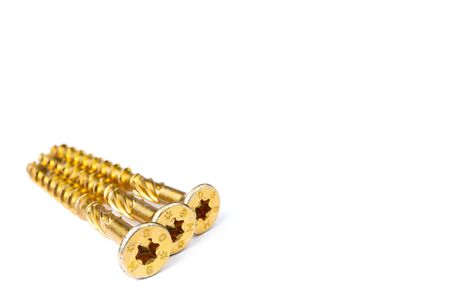 Gold torx screw isolated on white. Yellow zinc chipboard screw Torx, , full thread close upの写真素材