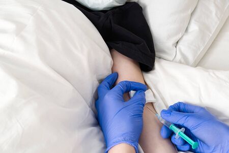 doctor make vaccinating to patient. vaccination of a boy at home from viruses and colds. health care...