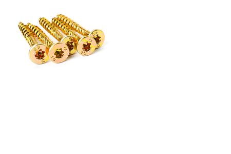 Torx yellow zinc head screws. Gold screws scattered randomly on a white background.の写真素材