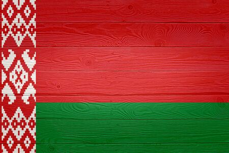 Belarus flag painted on old wood plank background. Brushed natural light knotted wooden planks board texture. Wooden texture background flag of Belarusの写真素材