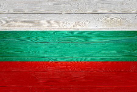 Bulgaria flag painted on old wood plank background. Brushed natural light knotted wooden planks board texture. Wooden texture background flag of Bulgariaの写真素材