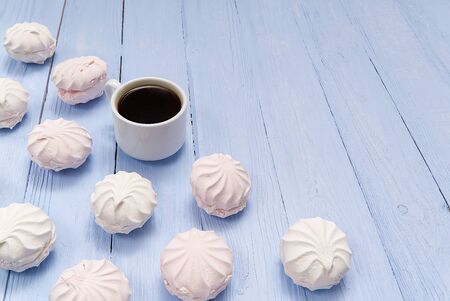 Good morning banner. Cup of coffee and homemade dessert zephyr, Zefir on light blue wood background. Top view. Food Photography with copy spaceの写真素材