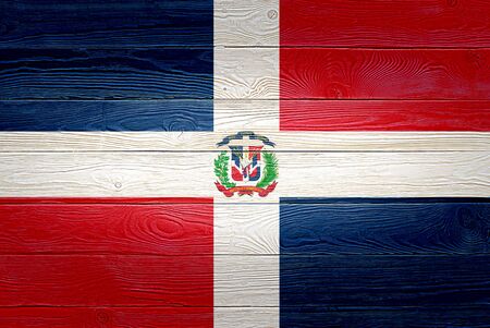 Dominican Republic flag painted on old wood plank background. Brushed wooden board texture. Wooden texture background flag of Dominican Republic.の写真素材