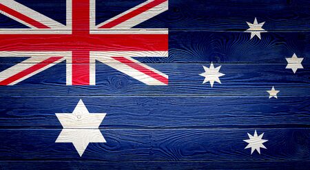 Australia flag painted on old wood plank background. Brushed natural light knotted wooden board texture. Wooden texture background flag of Australia.の写真素材