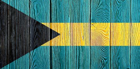 Bahamas flag painted on old wood plank background. Brushed natural light knotted wooden board texture. Wooden texture background flag of Bahamas.の写真素材