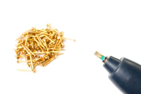 yellow zinc torx screws and electric screwdriver, isolated on white. screws for torx head bit.の写真素材