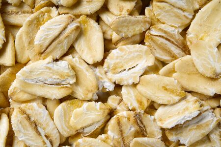Close up of oats flakes. oats flakes macro shoot. Oatmeal flakes texture. Background of golden oat flakes. Healthy food.の写真素材
