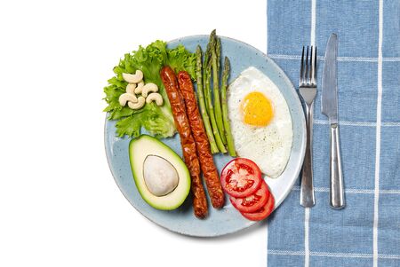 Healthy homemade breakfast with asparagus, fried egg and arugula. quarantine healthy eating concept. keto diet.の写真素材