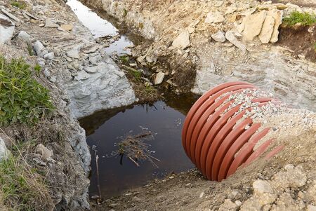 construction of a drainage ditch with plastic pipes. development of a new residential area in the...