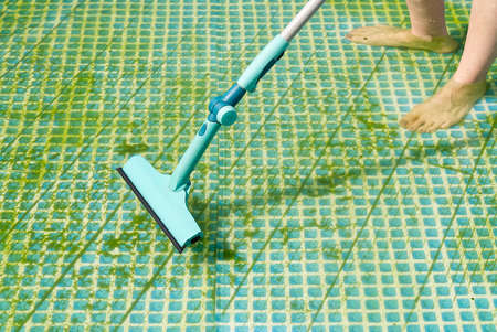Cleaning pvc inflatable swimming pool, Cleaning the dirty empty pool of algae, The beginning of the swimming season in the hot summer. Cleaning service concept.の写真素材