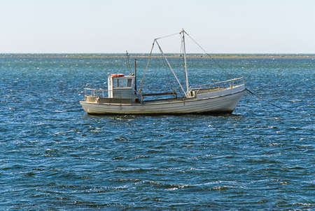 Old Traditional for baltic sea or scandinavian countries Vintage fishing boat in sea. minimalist...