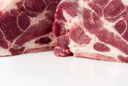 Slice of fresh raw pork meat on white background.の写真素材