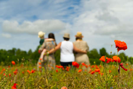Family Standing In Poppy Field on sunny day, blured, selective focus.の写真素材