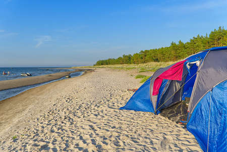 blue camping tent on sandy beach at seacoast. adventure travel concept with copy space. Tent in summer sunny day at baltic sea beach in Aegna Island,の写真素材