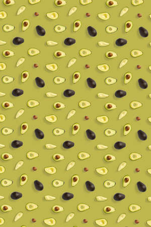 Avocado. Background made from isolated Avocado pieces on olive color background. Flat lay of fresh ripe avocados and avacado piecesの写真素材