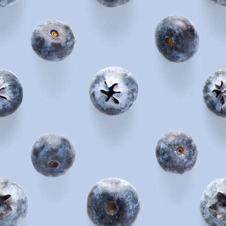 Trendy seamless pattern of blueberries. Blueberry pattern isolated on blue background. Blueberry...