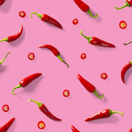 Red hot chilli seamless peppers pattern. Seamless pattern made of red chili or chilli on pink background. Minimal food pattern. Food background.の写真素材