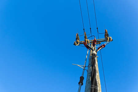 electric power sky lines and connections on a wooden post. Electric power lines and wires with blue sky. wooden electricity post against blue sky.の写真素材
