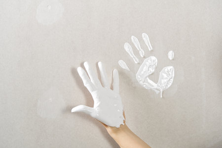 Hand print made with white paint on drywall. painter have funの写真素材