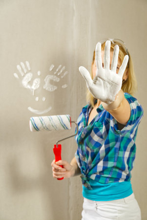 Hand print made with white paint on drywall. painter have funの写真素材