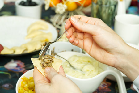 Woman cooking tasty dumplings, close up. diy homemade dumplings with different fillings. potato dumplingsの写真素材