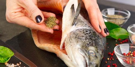 Salmon with spices on a blackstone board. Macro shot.の写真素材