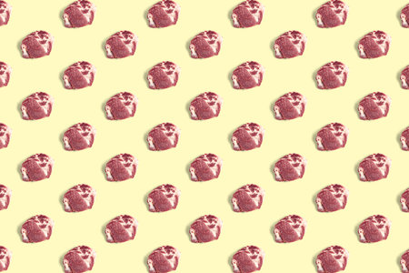 background with raw pork meat slices on yellow background, raw food background, not patternの写真素材
