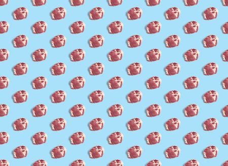 Seamless Pattern with raw pork meat slices on blue background, food patternの写真素材