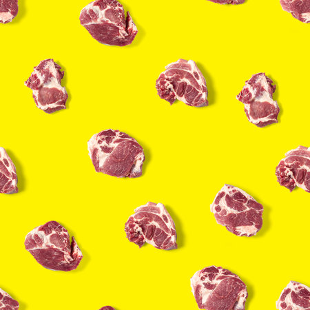 Seamless Pattern with raw pork meat slices on yellow background, food patternの写真素材