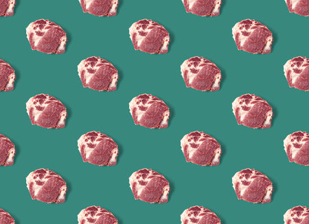 Seamless Pattern with raw pork meat slices on green background, food patternの写真素材