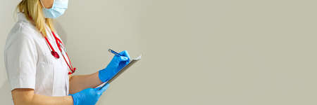 The doctor takes notes in prescription record information document.の写真素材