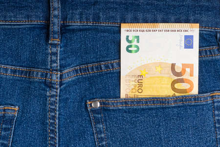 euro banknotes in blue jeans back pocket.の写真素材