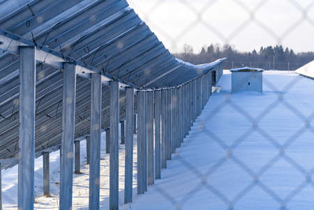 Solar panel back side field covered with snow. renewable energy in winter low efficiency. renewable...