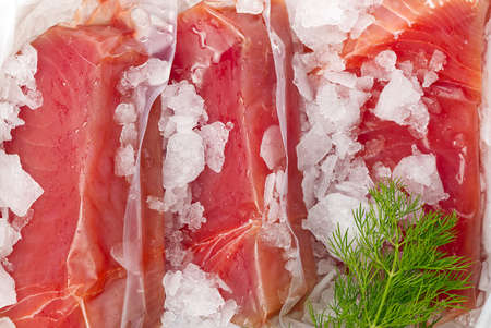 Frozen Tuna steak vacuum with ice on the counter the fishmarket. healfy food and nutrition conceptの写真素材