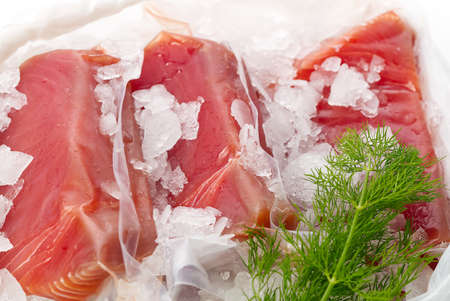 Frozen Tuna steak vacuum with ice on the counter the fishmarket. healfy food and nutrition conceptの写真素材