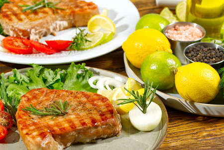 Tuna steak cooked on the electric grill. tunafish served on a plate with fresh herbs and vegetables. healthy nutritious, Healthy Eating for a Healthy Weightの写真素材