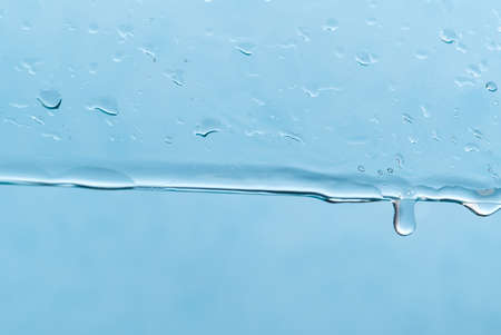 Abstract background. Drops of water on the window. water pours on a piece of clear glassの写真素材