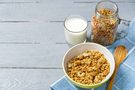 Yogurt with granola and fresh blueberries and raspberry, in glass. Healthy breakfast: yogurt parfait with granola and berriesの写真素材